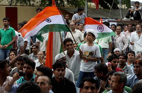 Protesters carrying the national flag gather at Jantar Mantar before Parliament March